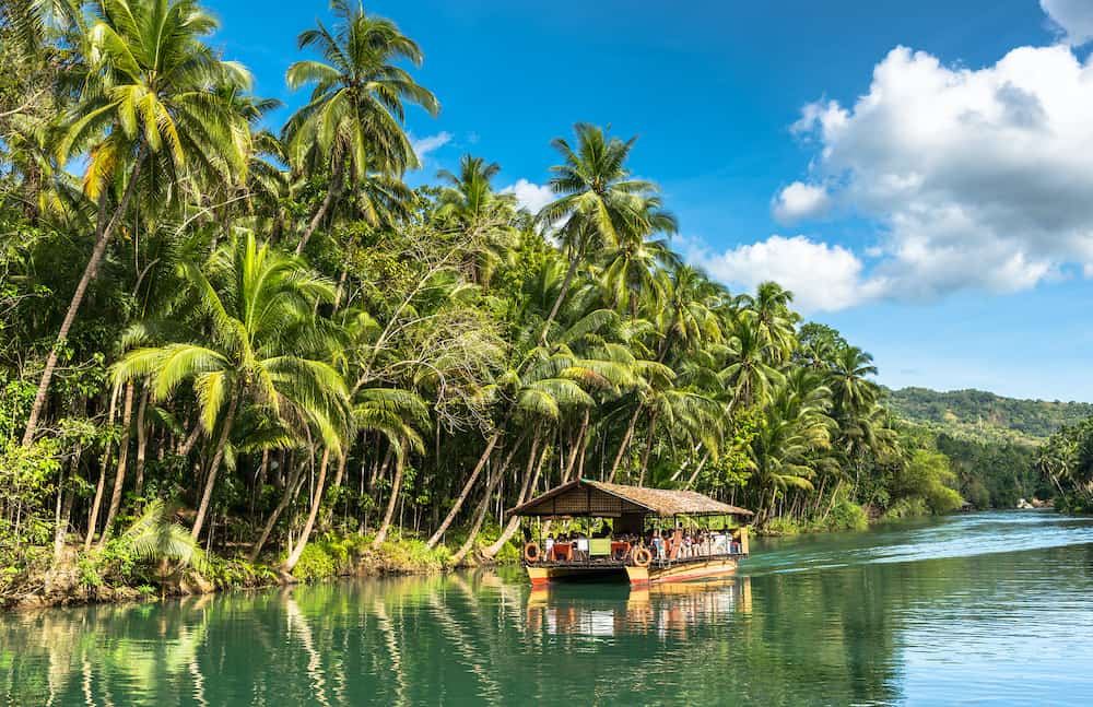 Traditional raft boat on the jungle-green Loboc River